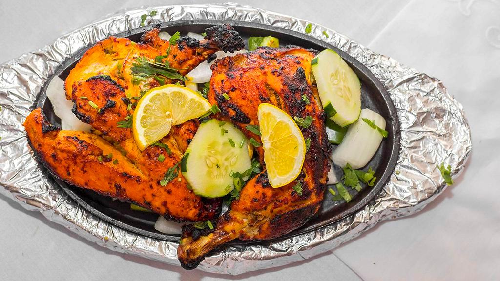Chicken Tandoori · Spring chicken marinated in fresh spices and lemon, then barbequed over flaming charcoal in the tandoor.