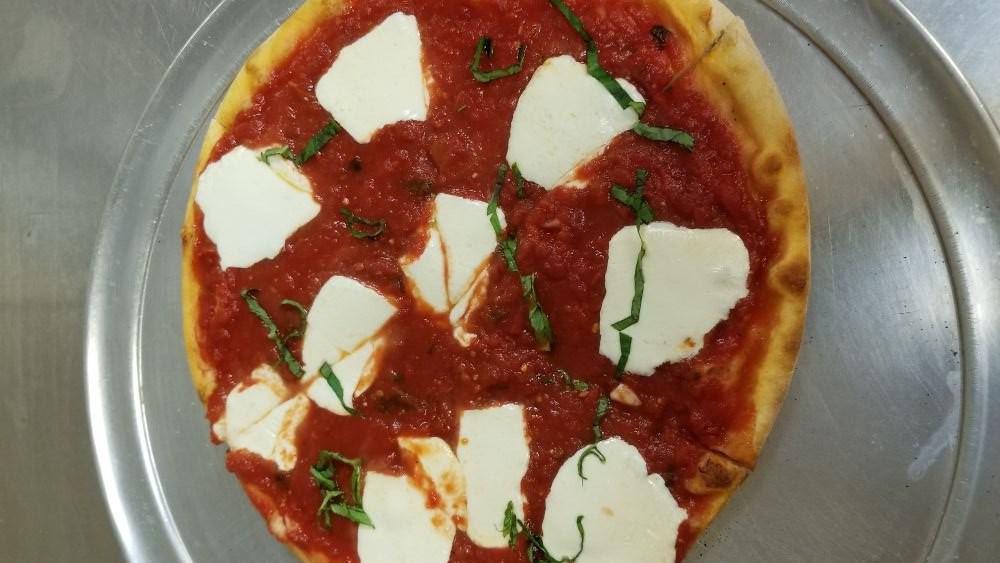 Margherita Pizza · White sauce, mozzarella cheese, fresh mozzarella, sliced tomatoes and fresh basil.
