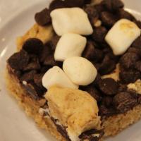 S'Mores Bar · Graham cracker crust, chocolate chips and marshmallow.  Campfire not included.