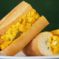 The Reeky Scramble (From Cheezy Vegan) · Tofu scramble with peppers, bacun and cheeze on a long roll.