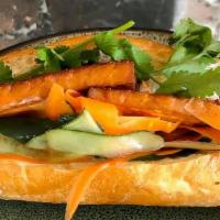 Tofu Banh Mi (By Rowhouse Grocery) · Tofu, vegan mayo, soy sauce, sesame oil, pickled cucumber, carrot and cilantro on a long roll.