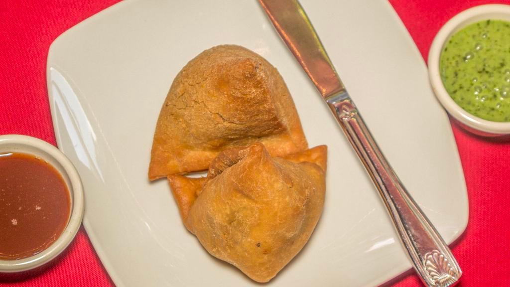 Veggie Samosa · Crispy triangular pastry turnovers filled with seasoned potatoes & green peas.