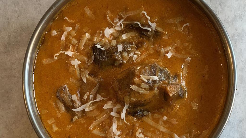 Goat Korma · A mughlai delight cardamoms flavored sweet and spicy curried bone-in goat in cream, cashews & raisins.