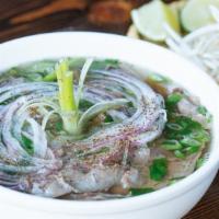 Saigon Beef Pho · Hearty beef broth, sliced rib eye, & flank. Traditional wide rice noodles, onion, green onio...