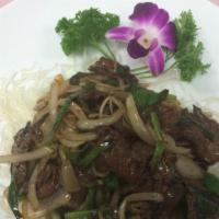 Thai Mongolian Beef · Sauteed beef with onion and scallion over a bed of crispy noodles. Served with choice of ric...
