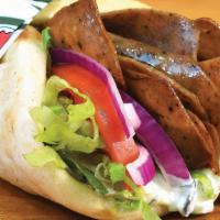 Gyro · Sliced gyro meat served on pita bread with lettuce, tomatoes, onions, and tzatziki sauce.