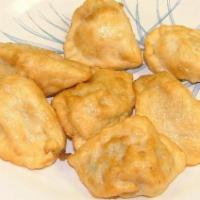 Dumpling (Steamed Or Fried) · Pork dumpling served with ginger sauce.