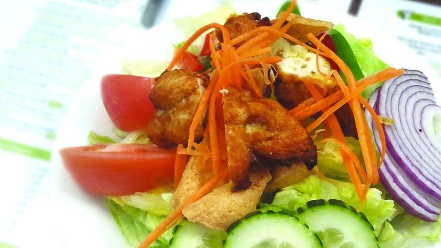 Salad Khag · Fried sliced chicken and fried tofu on a bed of green salad, served with peanut sauce and sweet spicy sauce.