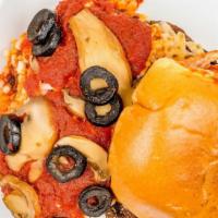 Beyond Pizza Burger · Beyond burger with marinara, mushrooms, black olives and vegan shredded mozzarella on a vega...