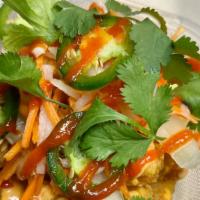 Banh Mi Tots · topped with sriracha mayo, pickled daikon and carrots, jalapeños, cucumber, cilantro and sri...