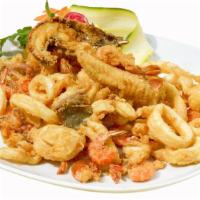 Fried Seafood Combo · Includes: crab cake, shrimp, scallops, and flounder, served with french fries and house salad.