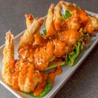 Butterfly Shrimp · 6 pieces deep fried shrimp with Spicy Honey Sriracha aioli.