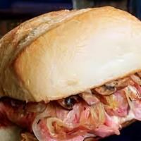 Classic Prime Rib French Dip · Thin sliced prime rib with caramelized onions and melted Gruyere cheese on a toasted French ...