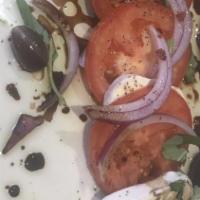 Caprese · Fresh mozzarella, served over French slices of ripe tomatoes, drizzled with extra virgin oli...