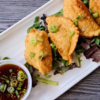 Pork Dumplings · Served with a sweet scallion dipping sauce