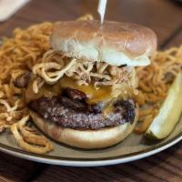 Smokehouse Burger · Bourbon BBQ sauce, slices of beef brisket, cheddar cheese, fried onion strings.