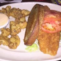 Crunchy Grouper Sandwich · Crunchy grouper, lightly breaded and fried, topped with swiss cheese, tomato and lettuce on ...