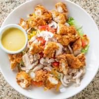 Southern Fried Chicken Salad · Fried chicken, Monterey jack, and cheddar cheeses, tomatoes and mushrooms. Served on a bed o...
