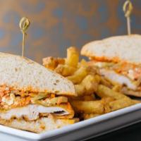 Crispy Buffalo Chicken Sandwich · FRANK'S RedHot®, blue cheese carrot celery slaw, ciabatta.