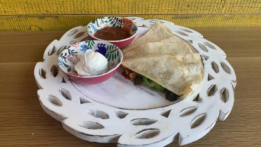 Vegetarian Quesadilla · 12-inch flour tortilla with Mexican cheese + roast vegetables. Served with sour cream and salsa.