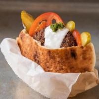 Falafel Burger · Falafel burger with tomatoes, pickles, sour cream, green spicy, add tahini
