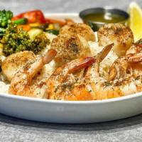 Grilled Shrimp & Scallops With 2 Sides · Jumbo Shrimp and scallops marinated in a garlic butter and grilled to perfection, served wit...