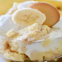 Banana Pudding · Creamy banana pudding with sliced bananas topped with vanilla wafers.