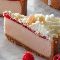 Raspberry Donut Cheesecake · Creamy raspberry and donut-flavored cheesecake sits on a graham cracker crust, topped with r...