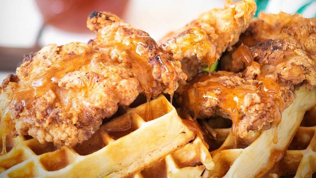 Chicken And Waffle · Golden fried chicken served on top of a fluffy Belgian waffle with a honey lemon butter glaze.