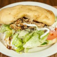 Jerk Sandwich · Jerk sandwich served with ranch, lettuce, tomatoes, and green peppers.