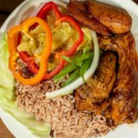 Brown Stew Chicken · Served with rice & peas and veggies.