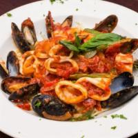 Seafood Pasta · Shrimp, calamari, , and red clam sauce.