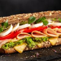 Turkey And Cheese Sandwich · Delicious sandwich made with turkey slices, cheese, lettuce, and tomatoes. Served with pickl...