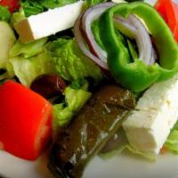 Greek Salad · Chopped greens, Kalamata olives, feta cheese, red onions, anchovies, cucumbers, and tomatoes...