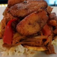 Ropa Vieja · Shredded beef flank stew, bell peppers, onions, black beans, tostones or maduros, & choice o...