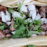 Carne Asada Tacos · Grilled steak, cilantro and onions.