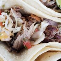 Pork Tacos · Slow roasted pulled pork, chipotle aioli, red picked onions and cilantro