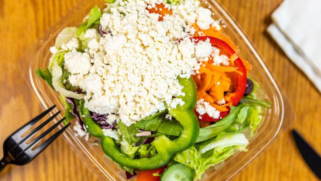 Greek · Syrian Bread, Greek, Feta, Iceberg, Baby Greens, Tomato, Cucumber, Red Peppers, Green Peppers, Kalamata Olives, Cabbage and Carrots.