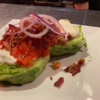 Baby Iceberg Wedge · Crumbled bacon, roasted cherry tomatoes, red onion, Bleu cheese dressing.