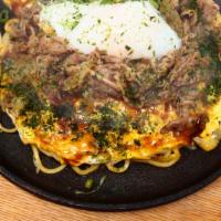 Sukiyaki Okonomiyaki · Topped with marinated beef - Layered Pancake meal of pork, vegetables, noodles, and eggs