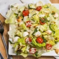 Caprese Salad · Romaine lettuce, fresh mozzarella, sliced tomatoes & pesto sauce.
