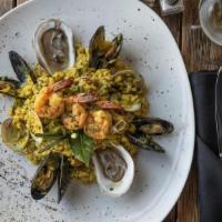 Signature Seafood Risotto · Italian arborio rice with clams, mussels. shrimp, calamari and saffron in a seafood base.