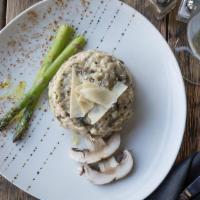 Signature Mushroom Risotto · Italian arborio rice with mushrooms, asparagus and shaved parmesan cheese, topped with a dri...