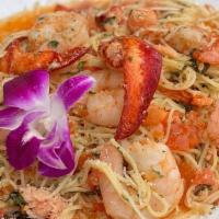 Lobster & Shrimp Scampi · Sautéed Lobster, Shrimp, and tomatoes in a white wine and lobster base sauce. Served over pa...