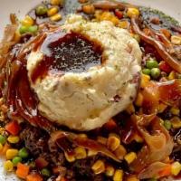 Shepards Pie · Ground beef Demi glaze served over mashed potatoes, carmelized onions and a medley of vegeta...