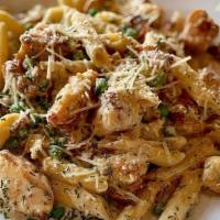 Chicken Carbonara · Sautéed chicken tenderloins with creamy alfredo sauce, peas and bacon.  Served with your cho...