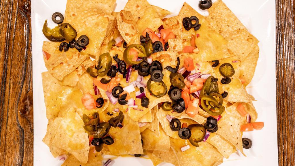 Junction Nachos · Tortilla chips covered in cheddar cheese, jalapenos, diced tomatoes, red onions & black olives. Side of sour cream & salsa.
ADD CHICKEN, PORK or CHILI $2.00
ADD GUACAMOLE .75