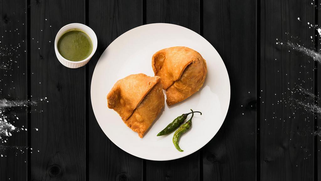 Samosa Classic · Fried pastry with savory-filled spiced potatoes, onions, and peas.