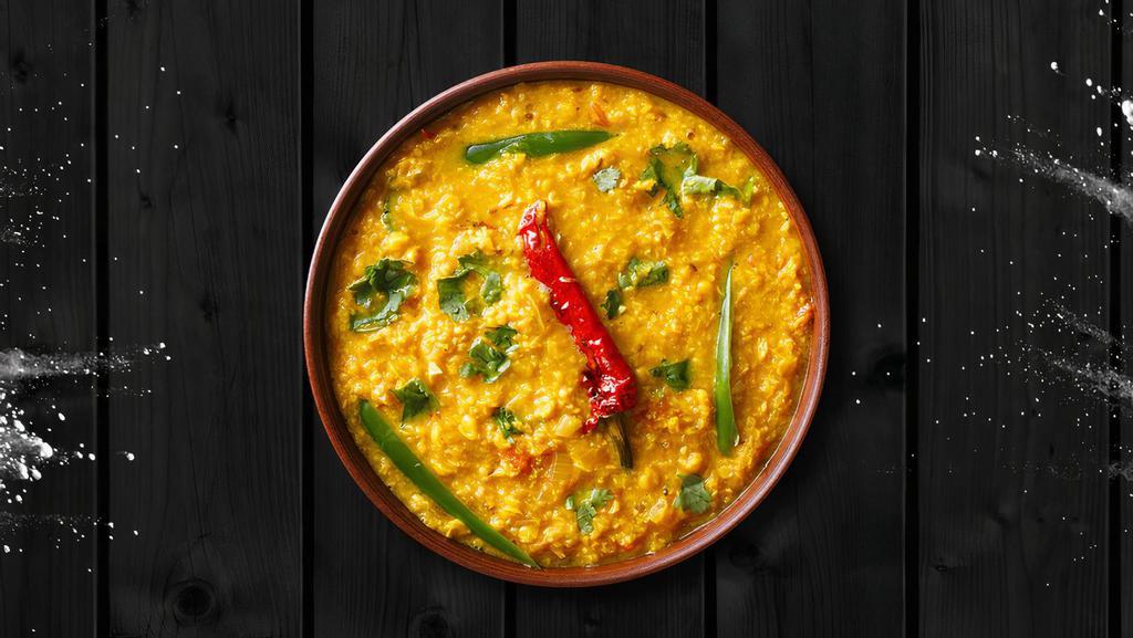 Tempered Golden Lentils · Yellow lentils, cooked to perfection over a slow flame and tempered with 'ghee' and spices.