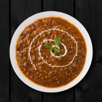Creamy Black Lentils · Black lentils slow cooked till tender and tempered with Indian spices and finished with fres...